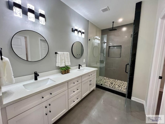 406 Valle Alto Dr, Los Fresnos, TX 78566 - bathroom with a stall shower, double vanity, and tile patterned floors