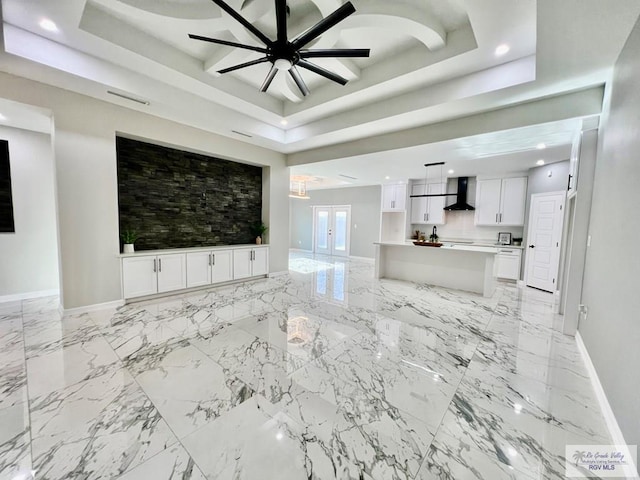406 Valle Alto Dr, Los Fresnos, TX 78566 - unfurnished living room with a raised ceiling, a ceiling fan, recessed lighting, and light marble finish flooring