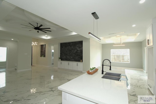406 Valle Alto Dr, Los Fresnos, TX 78566 - kitchen with a tray ceiling, open floor plan, light marble finish flooring, and recessed lighting
