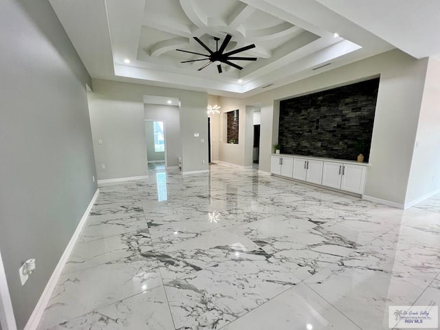 406 Valle Alto Dr, Los Fresnos, TX 78566 - unfurnished living room featuring a raised ceiling, ceiling fan, and light marble finish flooring