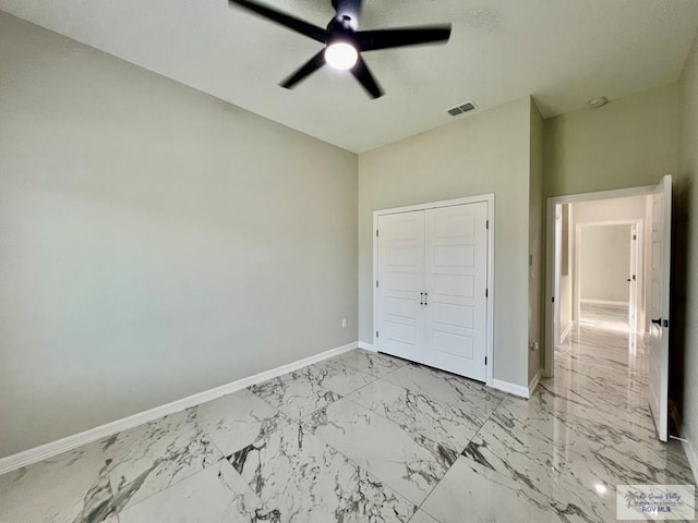 406 Valle Alto Dr, Los Fresnos, TX 78566 - unfurnished bedroom featuring light marble finish flooring, a closet, and ceiling fan