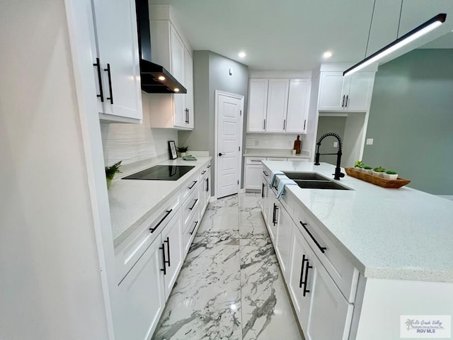 406 Valle Alto Dr, Los Fresnos, TX 78566 - kitchen with black electric cooktop, wall chimney exhaust hood, light marble finish flooring, recessed lighting, and decorative backsplash
