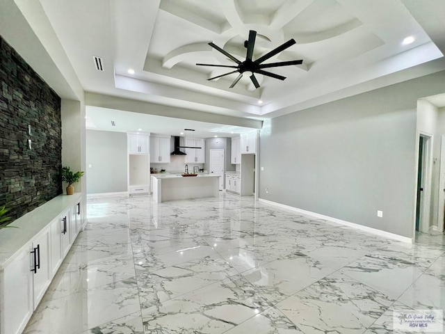 406 Valle Alto Dr, Los Fresnos, TX 78566 - unfurnished living room featuring ceiling fan, a raised ceiling, recessed lighting, and light marble finish floors