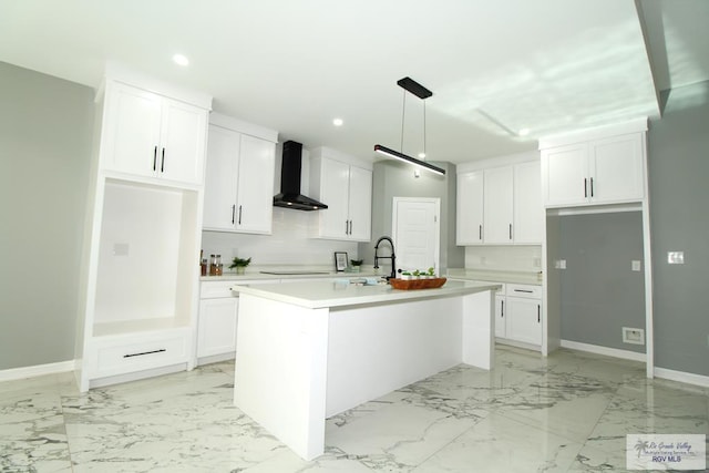 406 Valle Alto Dr, Los Fresnos, TX 78566 - kitchen with wall chimney range hood, light marble finish flooring, white cabinets, and recessed lighting