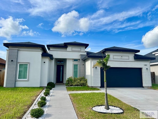 406 Valle Alto Dr, Los Fresnos, TX 78566 - prairie-style house featuring an attached garage, concrete driveway, a front yard, and stucco siding