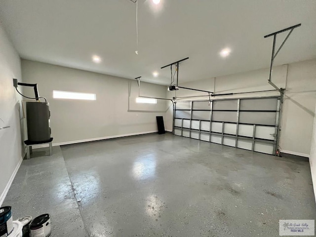 406 Valle Alto Dr, Los Fresnos, TX 78566 - garage with electric water heater and a garage door opener