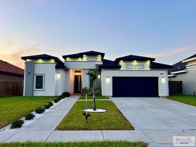 406 Valle Alto Dr, Los Fresnos, TX 78566 - modern home with an attached garage, stucco siding, and concrete driveway