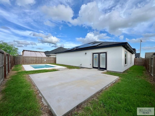 406 Valle Alto Dr, Los Fresnos, TX 78566 - back of house featuring a patio, roof mounted solar panels, a fenced backyard, and french doors