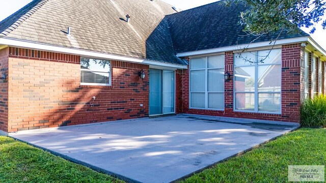 back of property with a patio