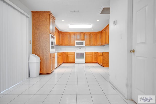 kitchen featuring white appliances and light tile patterned floors