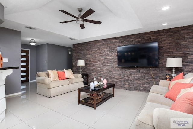 tiled living area with ceiling fan, a raised ceiling, visible vents, and recessed lighting