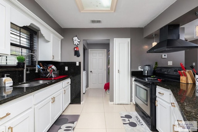 kitchen with light tile patterned floors, range with electric stovetop, a sink, visible vents, and island exhaust hood