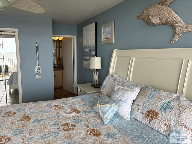 110 Padre Blvd Unit 407, South Padre Island, TX 78597 - tiled bedroom with ensuite bath and access to outside