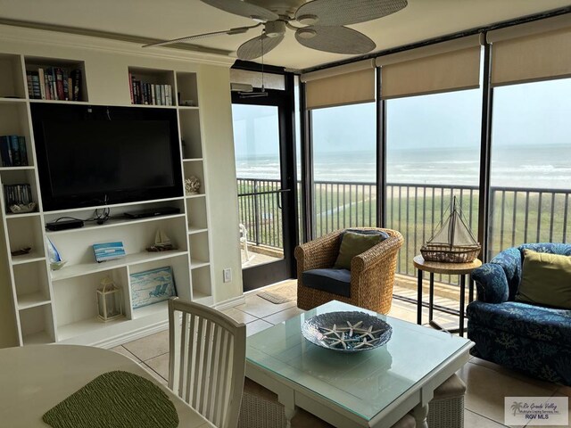 110 Padre Blvd Unit 407, South Padre Island, TX 78597 - sunroom featuring a view of the beach, tile patterned flooring, a water view, and ornamental molding
