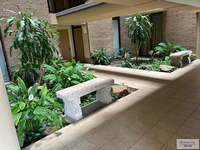 110 Padre Blvd Unit 407, South Padre Island, TX 78597 - exterior space with brick siding and a balcony