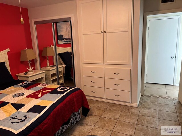 110 Padre Blvd Unit 407, South Padre Island, TX 78597 - bedroom featuring light tile patterned flooring and a closet