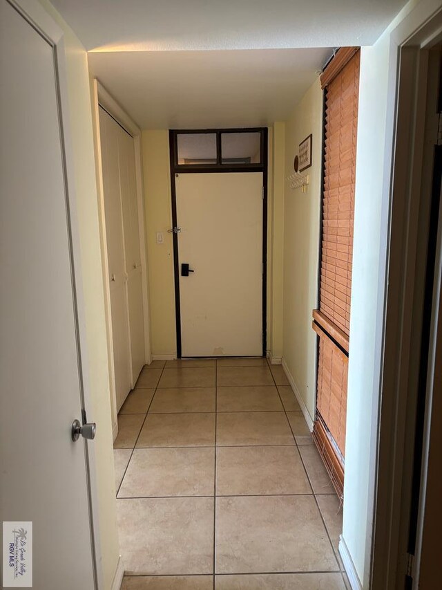 110 Padre Blvd Unit 407, South Padre Island, TX 78597 - hallway featuring baseboards and light tile patterned floors