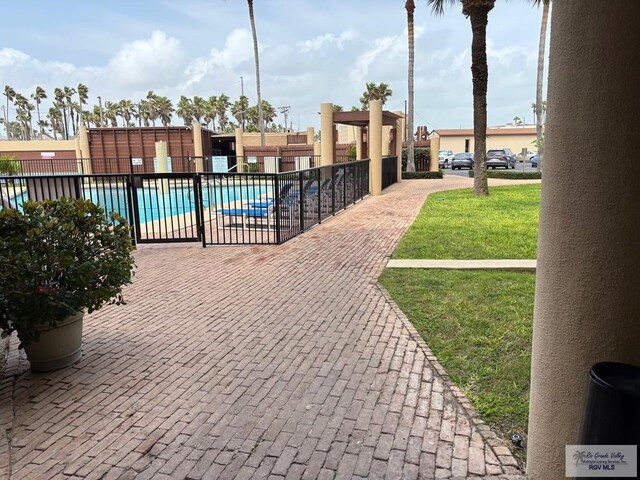 110 Padre Blvd Unit 407, South Padre Island, TX 78597 - community pool featuring fence