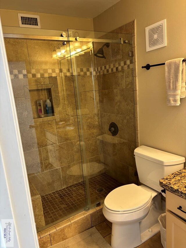 110 Padre Blvd Unit 407, South Padre Island, TX 78597 - bathroom featuring a shower stall, toilet, vanity, and visible vents