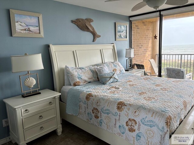 110 Padre Blvd Unit 407, South Padre Island, TX 78597 - bedroom featuring dark tile patterned floors, access to exterior, and a water view