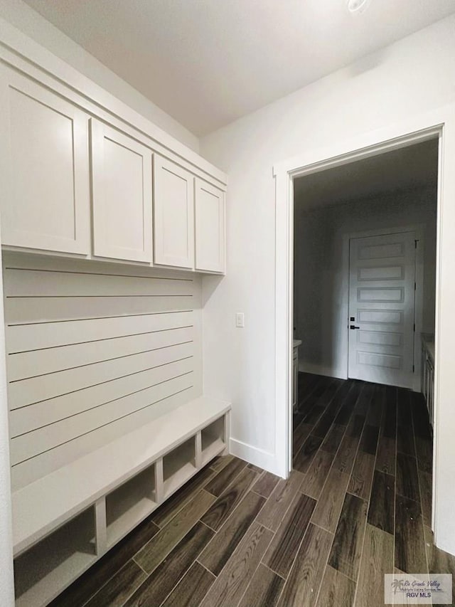 mudroom with baseboards and wood finish floors