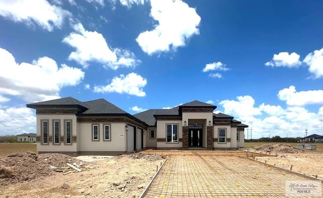 prairie-style house with an attached garage and stucco siding