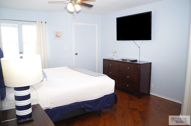 bedroom featuring ceiling fan and dark hardwood / wood-style floors