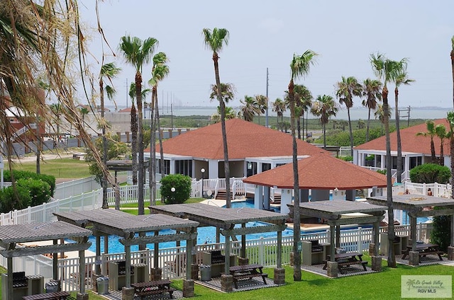 view of community featuring a pergola and a lawn