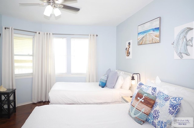 bedroom featuring ceiling fan and dark wood-type flooring