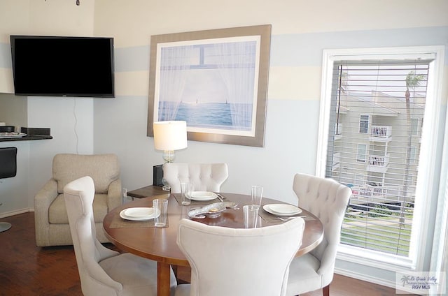 dining space with dark hardwood / wood-style flooring