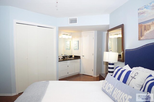 200 Padre Blvd Unit A314 1314, South Padre Island, TX 78597 - bedroom with dark wood-type flooring, a closet, and ensuite bath