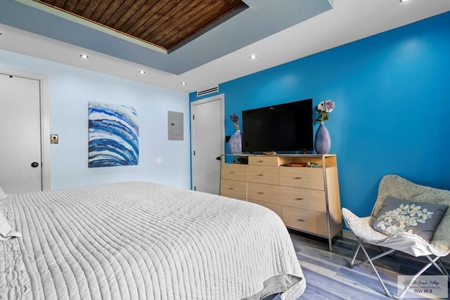 bedroom featuring wood finished floors, recessed lighting, a tray ceiling, and wooden ceiling