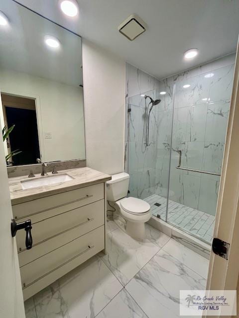 bathroom with an enclosed shower, vanity, and toilet