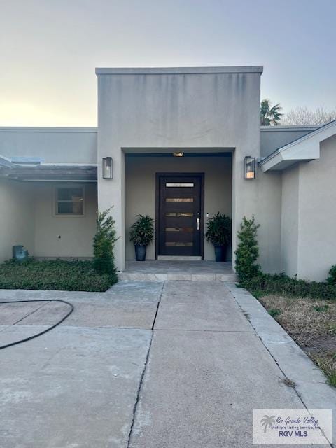 view of exterior entry at dusk