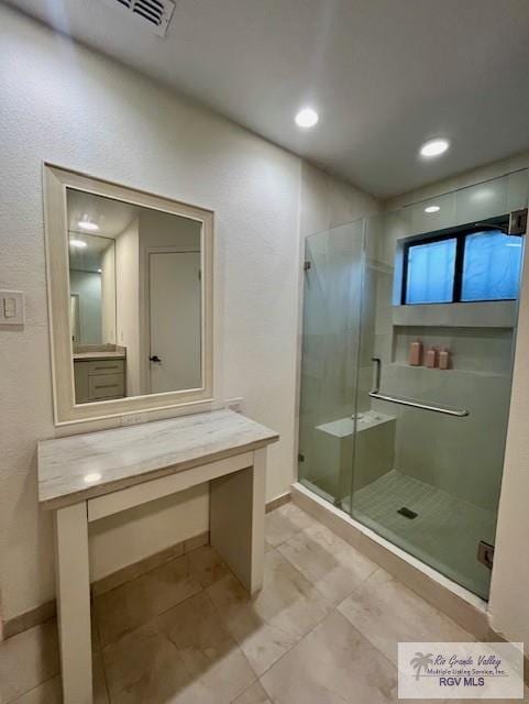 bathroom featuring vanity and an enclosed shower