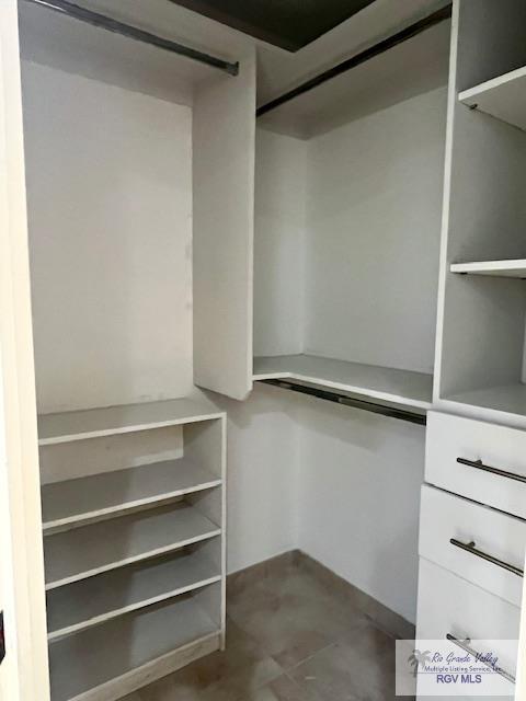 spacious closet with a barn door