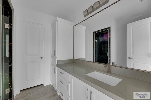 bathroom with hardwood / wood-style floors and vanity