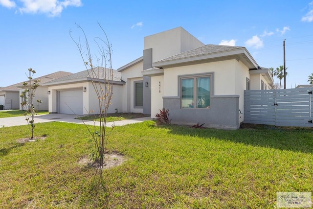 prairie-style house with driveway, an attached garage, fence, a front lawn, and stucco siding