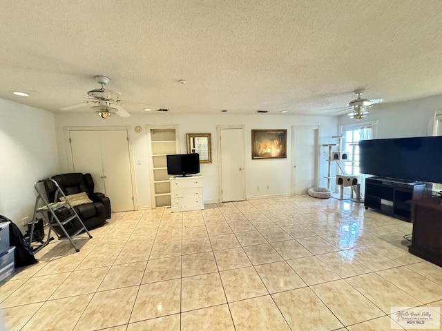 living room with light tile patterned flooring and a textured ceiling