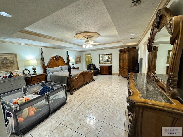 bedroom with ceiling fan, crown molding, a textured ceiling, a tray ceiling, and light tile patterned flooring