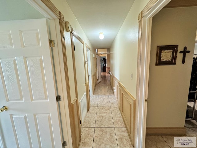 hall with light tile patterned floors