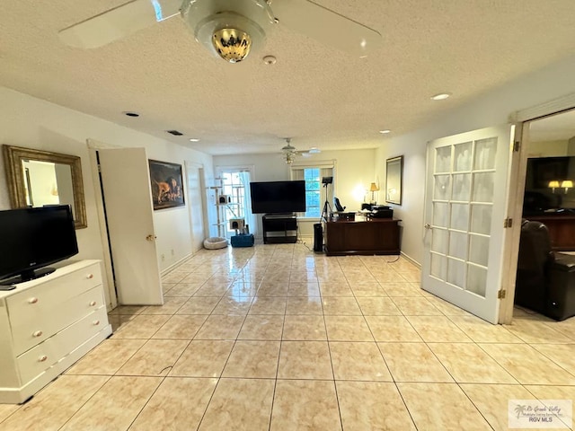 interior space featuring ceiling fan and a textured ceiling