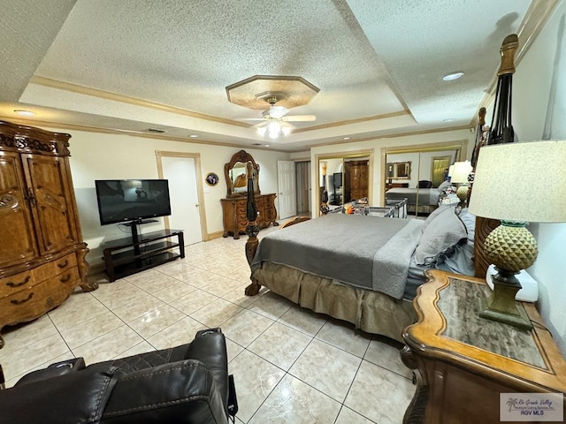 tiled bedroom featuring french doors, a raised ceiling, ceiling fan, ornamental molding, and a textured ceiling