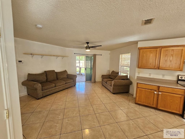 1149 Champlain Dr, Brownsville, TX 78526 - tiled living room with a textured ceiling and ceiling fan