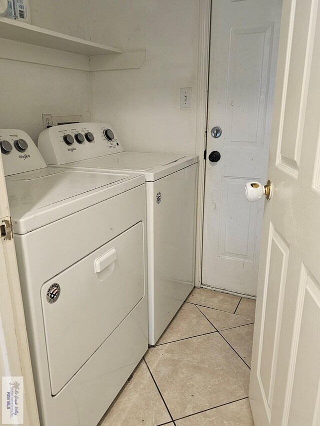 1149 Champlain Dr, Brownsville, TX 78526 - clothes washing area with washing machine and clothes dryer and light tile patterned flooring