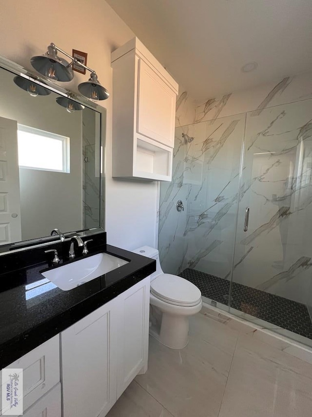 full bath with marble finish floor, toilet, vanity, and a marble finish shower