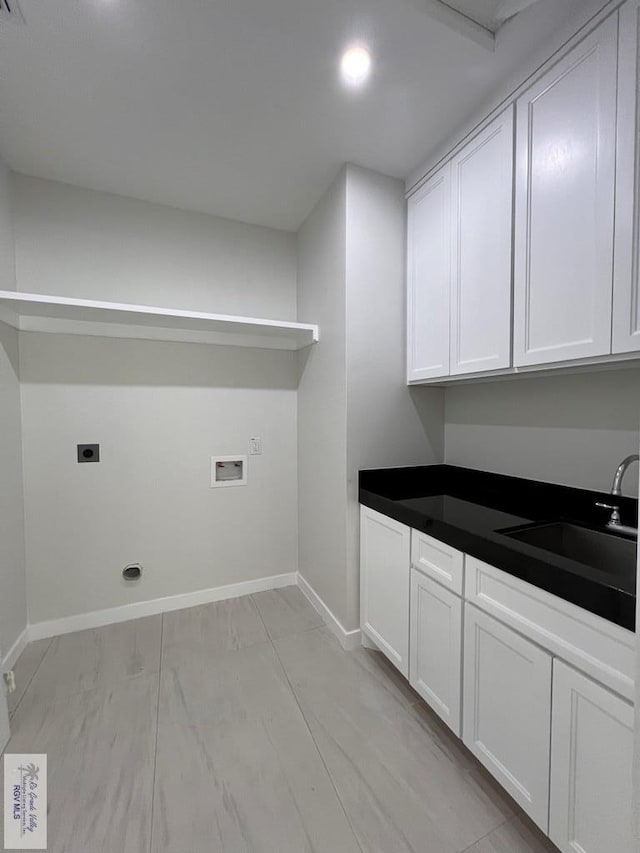 laundry room featuring washer hookup, cabinet space, a sink, electric dryer hookup, and baseboards