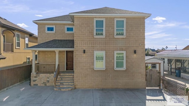1013 Tarpon Ave, Port Isabel, TX 78578 - rear view of property with a shingled roof and a gate