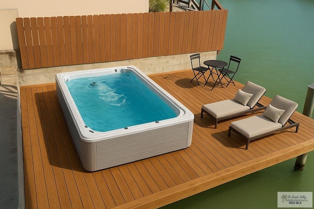1013 Tarpon Ave, Port Isabel, TX 78578 - view of swimming pool featuring a hot tub and a wooden deck