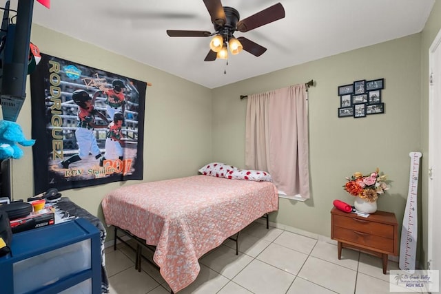 tiled bedroom featuring ceiling fan